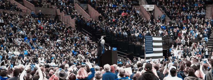 Bernie Sanders speaking to a very large crowd during one of his presidential campaigns