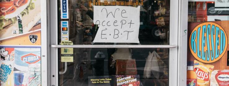 Shop door with We Accept EBT sign